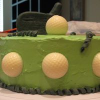 Golf Cake Made for my father in law's 58th birthday. Golf balls made out of white chocolate. Club made from fondant. Chocolate cake w/...