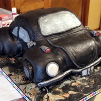 1St Vw Bug Hopefully I will get better at this. My first VW Bug. Some white some chocolate cake. Iced w/buttercream under MMF. Airbrushed pearl. Tag...