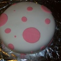 My First Cake My very first cake ever, made just for fun. Two 9 inch cakes, white with white frosting, covered in fondant with colored fondant circles. I...