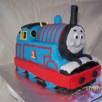 3D Thomas Cake This was my son's first birthday cake. I'd never put fondant over a shaped cake before! Buttercake with fondant.