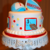 1St Birthday Cake - Boy 1st birthday cake - sports themed - 8" round.Hat was formed with the mini-ball pan and rice krispie treats.Entire cake was done in...