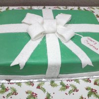 Present Cake-Large dark choc cake, choc mouse filling, choc bc & mmf(green) with rolled fondant ribbon with sugars for sparkle. 2 12x18 cakes on top of...