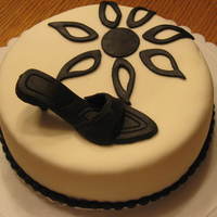 Black And White Cake WASC covered in MMF. Shoe is gumpaste/fondant. I made it for a coworker who is turning 50.