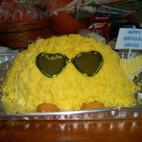 Ashlee Birthday Cake This is a yellow cake baked in a bowl to give its roundness. I then piped buttercream icing and the grass tips. The glasses are kid sized...