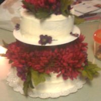 Buttercream With Silk Flowers A friend of mine requested this cake... keep in mind that I am a novice, this was my first tiered cake!! Buttercream with silk flowers. TFL...