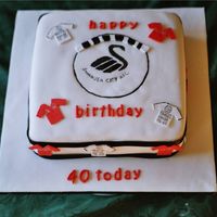 Football Cake I made this for a football fanatic,it's his favourite team,the logo was hand painted on the cake.