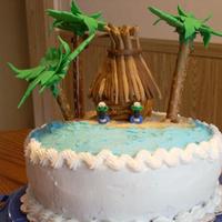 Luau Cake Red Velvet cake, fondant palm fronds atop pretzel rods, fondant tiki hut roof and tiki heads flanking the door. Pretzel sticks on sides of...