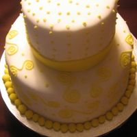 Yellow And White Yellow and white cake covered in fondant with bc accents.