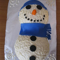 Snowman White cake, buttercream icing, snowman with cornelli lace and fondant scarf, cap, nose and black accents
