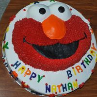 Elmo Brithday Cake Used a 14" single layer white cake and placed the Elmo cake from the Wilton Elmo cake pan. Frosted with buttercream. Gift boxes along...