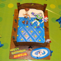 Andy's Bed Toy Story Cake I made for my son's 3rd birthday. Used two 9x13 cakes stacked and then used his toys to decorate.