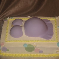 Belly Cake With Dots And Daisies Gender neutral belly cake with fondant dots and gumpaste flowers.