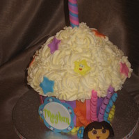 Dora Goes To Giant Cupcake Mountain Giant Cupcake -bottom covered in fondant and top buttercream. Dora and accents made of fondant.