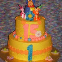 Winnie And Friends Buttercream Cake w/Fondant Decorations for a brother turning 1 and a sister turning 15.