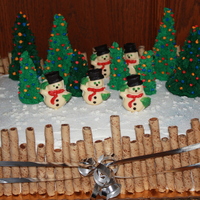 Holiday/winter 2009 Cake Layer cake with cookie fence, Sugar cone trees and molded chocolate snowmen.