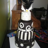 B & W Birthday Cake 4 tiers, alternating chocolate and WASC cake with vanilla and chocolate mousse filling. SPS system used for support. Covered in MMF.