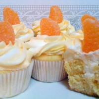 Orange Creamsicle Cupcakes Orange cupcakes with cream filling, iced with buttercream and topped with an orange gummy candy