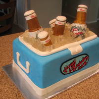 Coors Light Ice Chest Cake My daughter made the rice krispy beer bottles...I hand painted the labels. Thank you to mommyle for the help with answering my question...