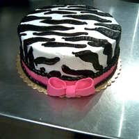 Zebra Striped Cake 8" round iced in whipcream with buttercream stripes. Fondant Bow