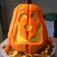 Birthday Halloween Jack-O-Lantern Orange cake, Orange flavored and colored buttercream. Face carved out of cake. A fun one to do!!