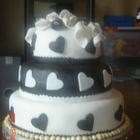 Black And White Fondant My first tiered cake, 2nd time using and making fondant. Don't like the gold balls around the base but the girl I made it for wanted...