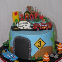 Lightening Mcqueen Birthday Cake This cake was made for a three year old that loves Lightening McQueen. I added details such as a rock slide on the road, a caution sign...