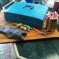 Tackle Box Cake this is a tackle box cake i made. the tackle box is covered in buttercream and the board, fish, and worms are fondant. the hooks are made...