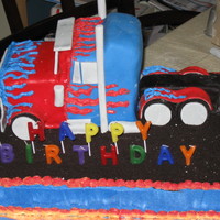 Transformer's Optimus Prime Truck This was for a 5 year old's bday. Crushed oreos as gravel, fondant on the truck, gumpaste for the wheels and truck accessories.