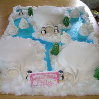 Happy Feet Igloos are covered in fondant, penguins are made with truffles, the snow is cotton candy.