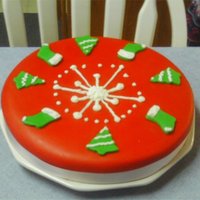 Tree And Stockings White cake with red marshmallow fondant and green mmf tree's and stockings. Buttercream snowflake