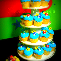 Super Mario Cupcakes French Vanilla Cake, buttercream icing. Accents made out of fondant and mini marshmellows. The Mario figure on the "mini cake"...