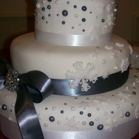 Snowflakes, Pewter, And Pearls, New Year's Eve Wedding Cake This bride loved sugarsugargal's Pewter and Pearl Wedding Cake. Thanks so much for the inspiration! Lemon with raspberry filling,...