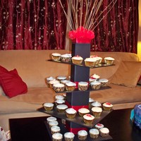 Tower My first cupcake tower. The display piece matches the centerpieces for the tables. Just used for a teacher's luncheon. TFL