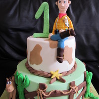Toy Story - Woody Two tier chocolate mudcake, covered in ganache and coloured fondant. All accents including Woody/Bullseye & 1 and made from fondant.