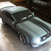 Car Groom's Cake This groom's cake is a 2011 Mustang. It's 17" long x 6" wide x 4" high. The logo and back lights were handpainted...