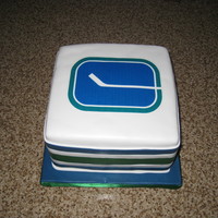 Vancouver Canucks Lemon cake with raspberry SMBC. Edible image photo on the top. Fondant stripes on the side.
