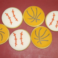 Basketballs And Baseballs My first real cookie attempt. These are 2.5" round sugar cookies with Fondarific tops and stenciled using Designer Stencils sports...
