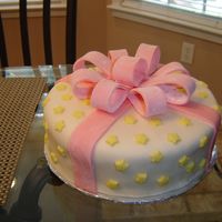 My First Cake I Sold! This was a yellow cake with fondant and stars. I used gum paste for the bow. I thought it turned out really well for my third cake over all...