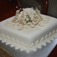 Diamond Wedding Anniversary Cake Diamond shape wedding anniversary cake. Covered in Ivory icing and decorated with Ivory sugar crafted flowers.