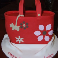 Radley Handbag Made from standing an 8 x 10" Oblong cake on its end and carving to make the bag shape. Covered in red fondant and decorated with...