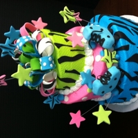 Skating Fun Cake for a skating party; each tier is a different flavor, zebra stripes to top and bottom tiers, polka dots on the middle tier, multi-...