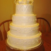 Simple Elegance 4-tier round red velvet cake. Covered with white fondant and pearl glaze, piped on scroll work and silver dragees.