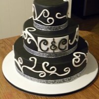 Black And White Swirls This is a three tier wedding cake covered with vanilla flavored black fondant and white fondant swirls.