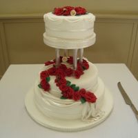 Red Roses Wedding Cake I made this for my cousin... red fondant roses draping down the cake.I used lustre dust to make it shimmer.She just loved it as she wanted...