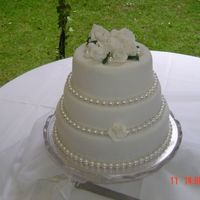 1St Wedding Cake This was for my niece. Exactly how she wanted it. Plain white fondant with pearls and gumpaste roses on top.