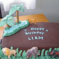 Animal Safari Cake chocolate fondant covered cake, with chocolate animals. Everthing is edible even the palms.