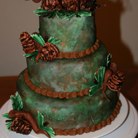 Camo Cake/woodsy This was my first fondant cake and stacking cake! It is a peanut butter cake with chocolate filling. Covered in Wilton's white fondant...