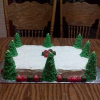 Son School Party Cake Italiian cream cake with white choc cream cheese icing. Fondant gifts with sugar cones covered in buttercream. Sugar crystals for the snow...