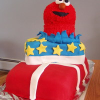 Elmo Present Cake 9x13 chocolate cake "wrapped" in red fondant and white fondant ribbon. Next is a yellow 9x9 cake "wrapped" in blue...