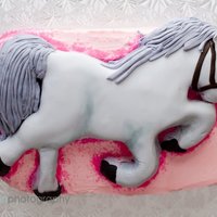 Gray Horse Pink layer cake with a gray horse on top.